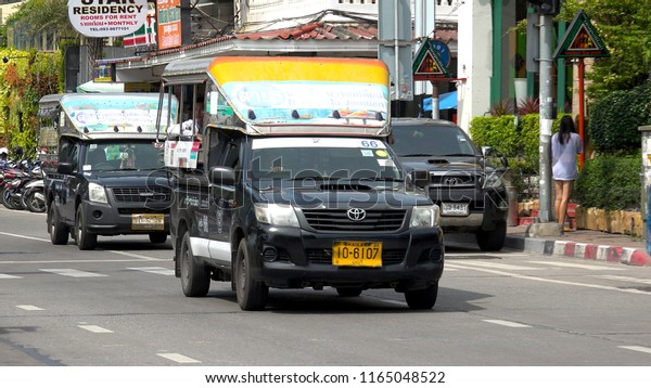 PATTAYA,  THAILAND -\
CIRCA AUGUST 2018 : SONGTHAEW at the street.  It is a passenger\
vehicle in Thailand adapted from a pick-up or a larger truck and\
used as a share taxi.