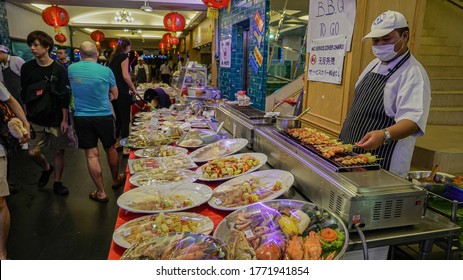 Pattaya, Thailand-june 2020: Male Salesperson A Street Cafe In A Medical Mask From The Coronavirus In A Street Market