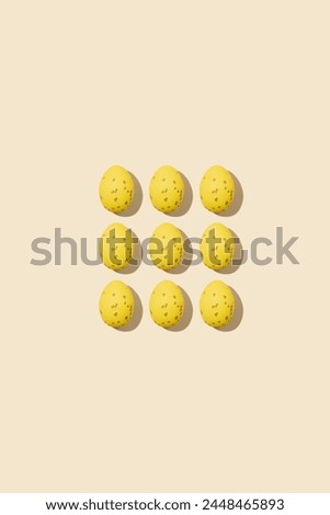 Pattern of beautiful yellow chicken eggs for Easter on yellow background, top view