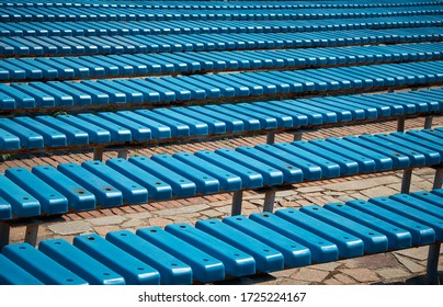 Pattern Of Blue Plastic Benches. Striped Benches In Daylight. Concert Venues In Front Of The Crowd.