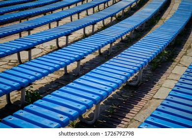 Pattern Of Blue Plastic Benches. Striped Benches In Daylight. Concert Venues In Front Of The Crowd.