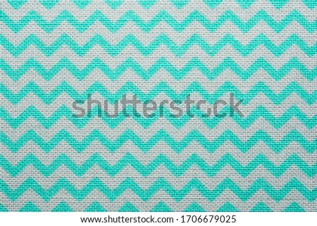 Pattern of blue and white striped zig zag. Macro textile texture