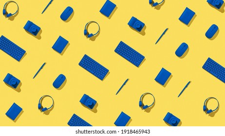 A Pattern Of Blue Workplace Accessories On A Yellow Background. Stylish Background. Flat Lay.