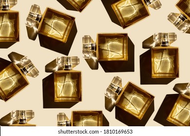 Pattern bottles of woman perfume on a pastel beige background, top view, flat lay. Mockup of gold fragrance perfume bottle mockup on pastel beige empty background.