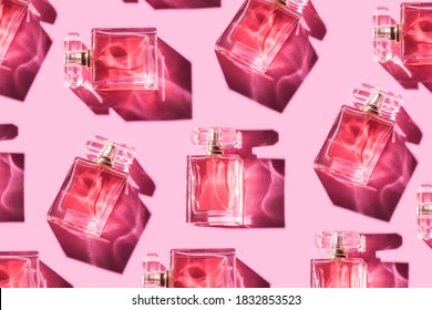 Pattern bottles of woman perfume on a pastel pink background, top view, flat lay. Mockup of pink fragrance perfume bottle mockup on pastel pink empty background