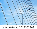 a pattern of bridge cable as a background of a street light