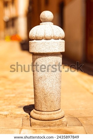 A pattern carved in stone, on a street in Madrid, Spain, with a blurred background
