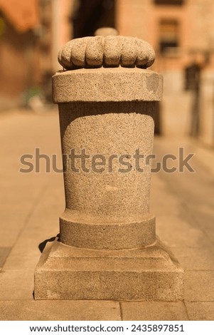 A pattern carved in stone, on a street in Madrid, Spain, with a blurred background