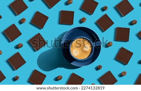 pattern chocolate and blue mug with espresso. blue background. chocolate coffee background