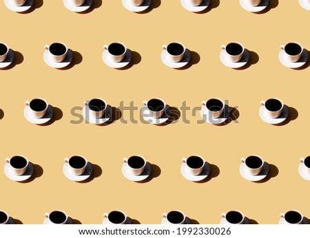 Pattern of coffee cup and plate, shadow of sun on beige terracotta background