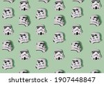 Pattern created of white Stormtrooper helmets from three positions – front, left and right sides. A top view with pastel green background.