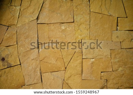 Pattern of decorative brown stone wall texture absract background.