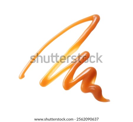 Pattern drawn with melted caramel close up isolated on a white background