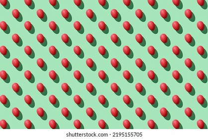 Pattern of easter eggs on green pastel background