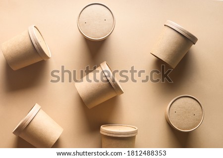 Pattern of eco-friendly disposable cardboard soup cups with shadow on brown paper background. Ecological individual package.