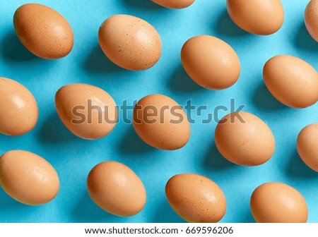 pattern of eggs on blue background, top view