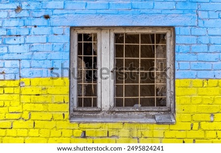 Foto Bild Muster Explosion beschädigt blau gelb Hauswand mit Fenster in der Ukraine