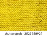 Pattern fabric made of wool. Handmade knitted fabric yellow wool background texture