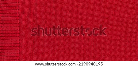 Pattern fabric made of wool. Handmade knitted fabric red wool background texture