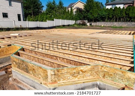 A pattern of floor joist in a house under construction
