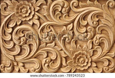 Pattern of flower carved on wood background.