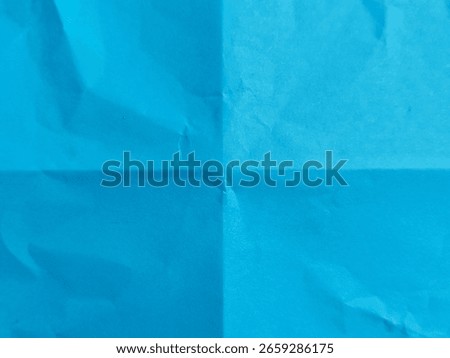 Pattern of folded blue paper. Blank blue paper texture background folded in four. Ideal for backgrounds, overlays, space for text, space for advertising copy.