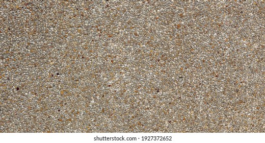 Pattern gravel floors washed gravel stone walls. Surface exposed aggregate finish, seamless granite rough texture background. External concrete floor with small pebble various sizes, color tone brown