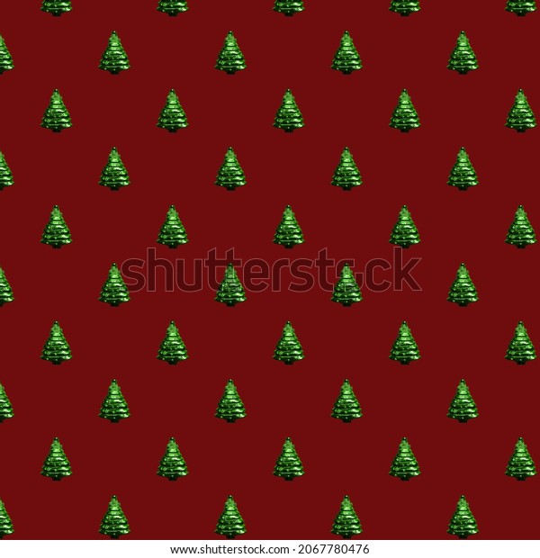 Pattern green Christmas tree on a red\
background.Christmas pattern decorations. Minimal composition\
seamless pattern background.Winter, Christmas  and New year\
concept. Top view, flat lay.greeting\
car
