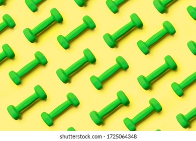 Pattern Of Green Dumbbells On A Yellow Background