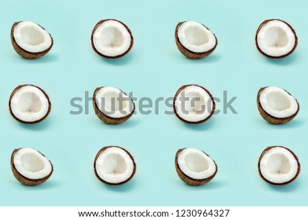 Pattern with half of shell coconuts on blue background. Top View,minimalism, creative cocnuts concept.