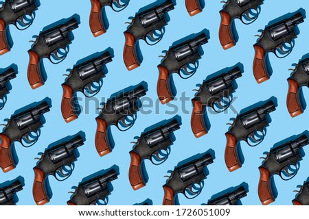a pattern of handguns on a blue background