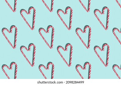Pattern of hard candy cane heart on blue pastel background