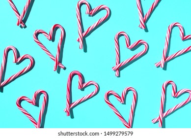 Pattern with hearts made of Christmas candy canes on blue background. Top view. Flat lay. Love, Valentines day concept. New year and Christmas card. - Powered by Shutterstock