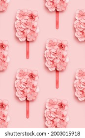 Pattern With Ice Cream On Wooden Stick Or Popsicle From Pink Flowers Of Hydrangea On Pastel Pink Background. Summer Minimal Concept. Creative Layout.