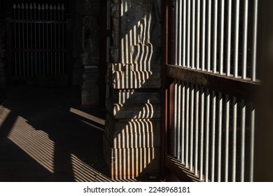 Pattern of light and shadow through a grilled window of an ancient Hindu temple in Tamil Nadu.