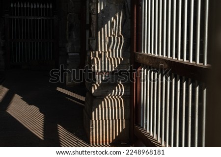 Pattern of light and shadow through a grilled window of an ancient Hindu temple in Tamil Nadu.
