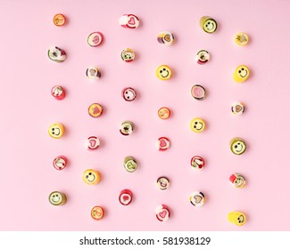 Pattern lollipops, candy on colorful pink background, top view flat lay. Sweet sucker, lollipop, candy, isolated minimal concept above decoration, food background