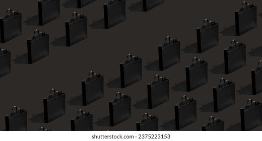 Pattern made from black paper shopping bags on black background. Black friday banner sale, shopping concept..