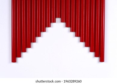 Pattern made by red pencils against white background.