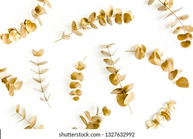 Pattern Made Of Gold Branches, Eucalyptus Leaves On A White Background. Flat Layout, Top View