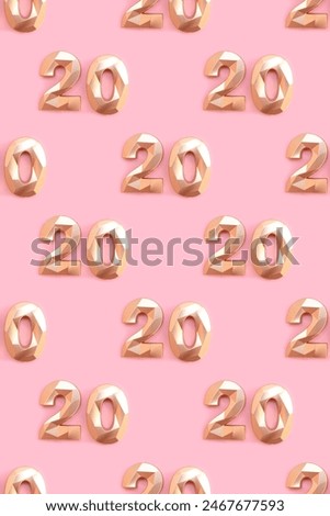 Pattern made of gold colored number 20 on a pink background. 