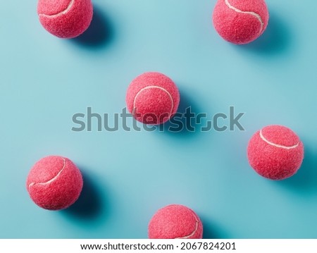 Pattern made with pink tennis balls on pastel pink background. Creative sport concept. Retro 80's or 90's aesthetic. Flat lay, top view.