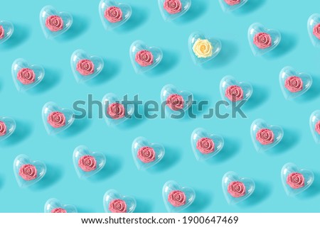 Pattern made of roses in transparent heart shape balloon. Flower wallpaper layout. Minimal flat lay background concept.