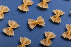 Colorful Pasta, Loop Noodles, Italian Pasta, Farfalle, Fusilli, Penne and  Others on a White Tablet Against a Neutral Background. Stock Photo - Image  of carbohydrates, decoration: 162951908