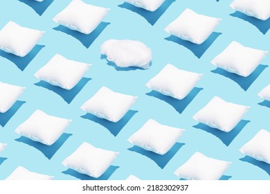 Pattern made of white pillows and one cotton cloud on serenity pastel blue background. Sleeping concept. Isometric flat lay. Break the pattern.