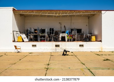 Pattern of messy chairs and tables in outdoor storage in Farol island, Algarve, Portugal