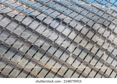 Pattern of metallic diamonds on modern building facade looks like a modern prison. Contemporary exterior shows a jail - like structure in modern architecture. Sad lifestyle and false freedom concept