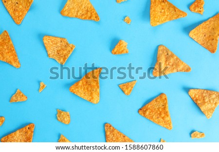 pattern mexican nachos chips on blue background top view