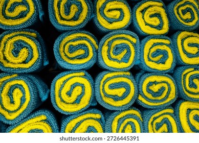 a pattern of microfiber towels in a row. abstract spiral background. wide, cheerful and vibrant pattern. automotive or cleaning banner.