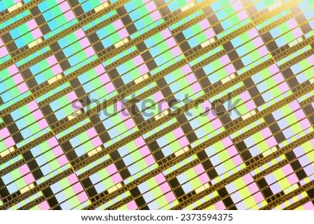 A pattern of microprocessor circuits on a silicon wafer. The semiconductors or central processing unit CPU microchips are fabricated from a silicon wafer with patterned layers of various materials.